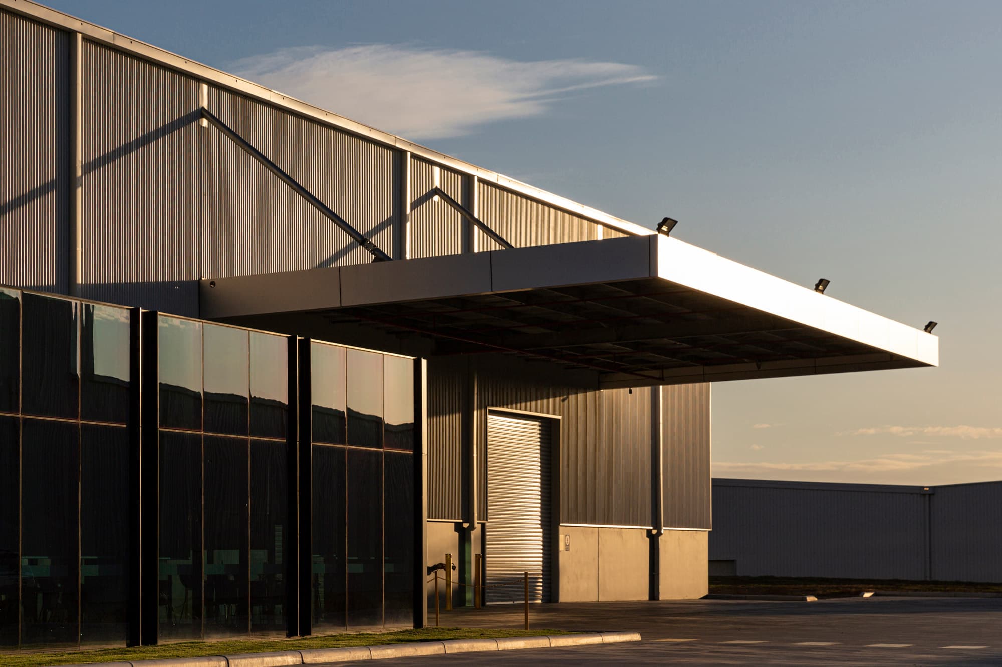 A modern South-East Queensland industrial facility at golden hour